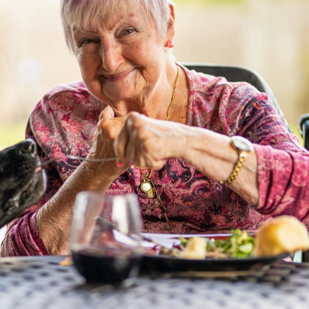 Woman enjoying a meal at Court House Care Home