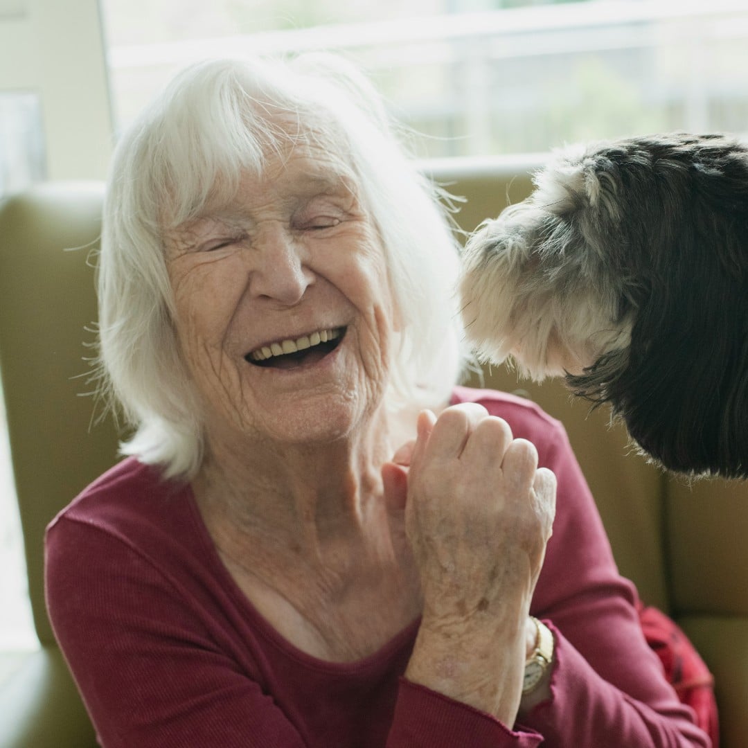 Woman resident at Court House enjoying a moment with our dog